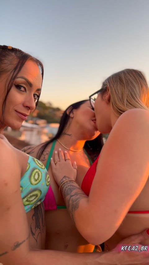 A late afternoon and three girls kissing passionately
