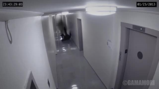 Security Camera Captures A Strange Figure Attacking A Man In A Hallway