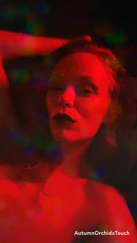Smiling at you and playing with my hair as colorful lights sparkle across my face...