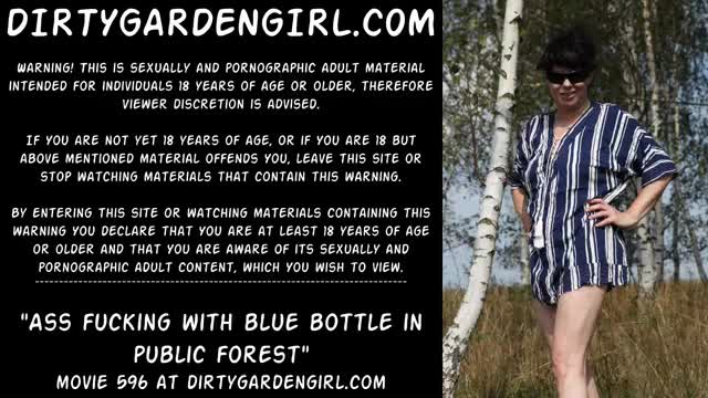 Ass fucking with blue bottle in public forest