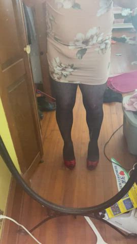 Perched on 3 in red heels w matching red bra and panties wearing her dress is the