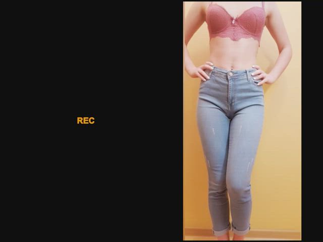 Holding on the left, letting go on the right in jeans and a perfect tummy
