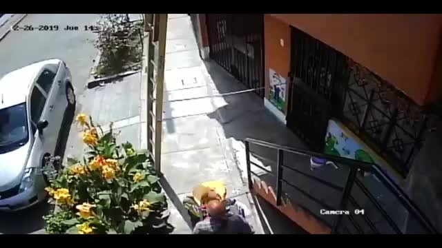 Elderly man approaches a guy working on a ladder on the sidewalk, instead of going