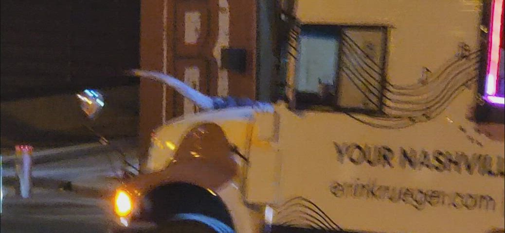 woman bending over and twerking in a skirt on a party bus.