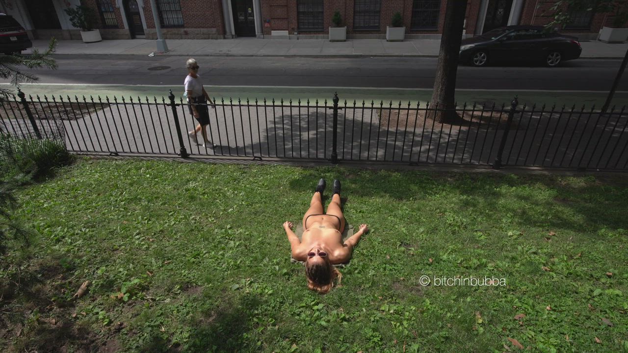 Sun tanning next to a busy street [F]